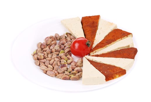 Tofu cheese and pistachios. Isolated on a white background.