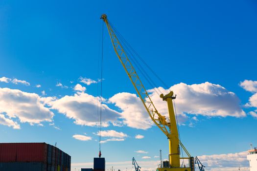 Sagunto port dock yellow crane in Valencia in a sunny day