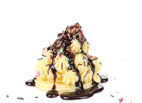 Vanilla cream and sprinkles. Isolated on a white background.