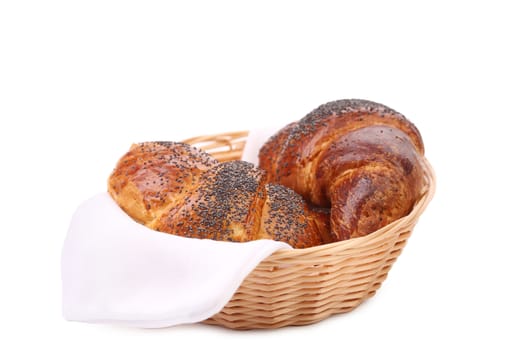 Tasty croissants with poppy on wicker basket. Isolated on a white background.