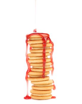 Stack of biscuits covered cherry jam. Isolated on a white background.