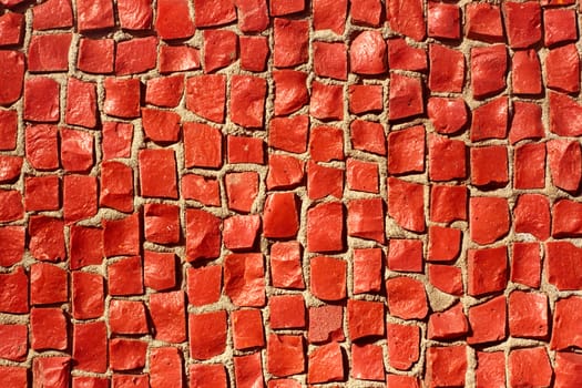 Detail of mosaic with small red stones in the bright sunlight