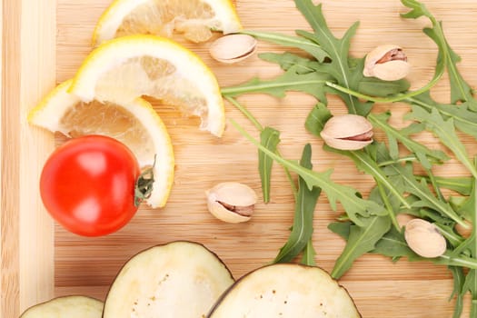 Vegetables on wooden board.  To be used as background.