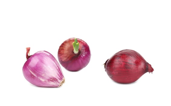 Three red onions. Isolated on a white background.