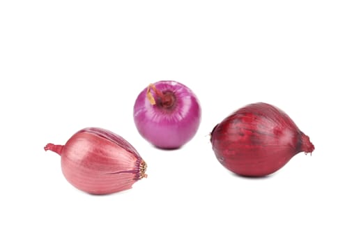 Three red onions. Isolated on a white background.