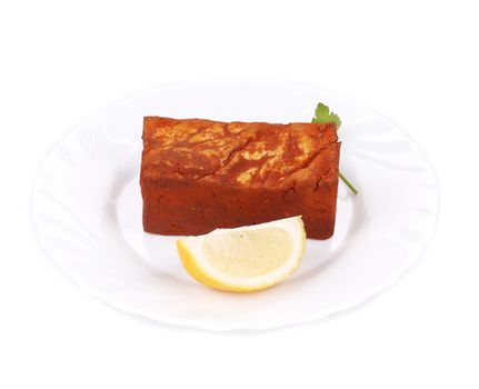 Tofu in paprika and lemon. Isolated on a white background.