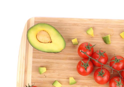 Fresh vegetables on cutting board. Isolated on a white background.
