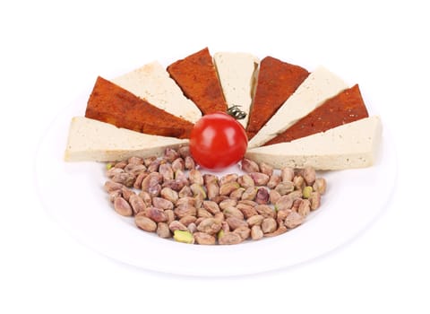 Tofu cheese and pistachios. Isolated on a white background.