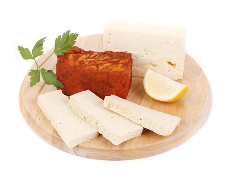 Tofu cheese with lemon on platter. Isolated on a white background.
