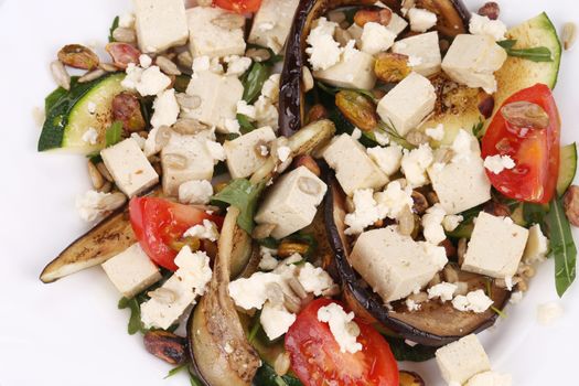 Salad with grilled vegetables and tofu. Isolated on a white background.