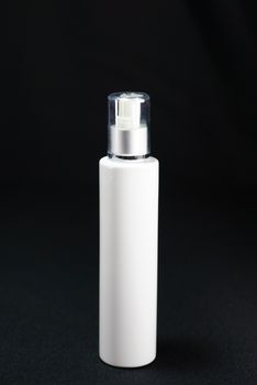 white pump bottle on black scene,shallow focus