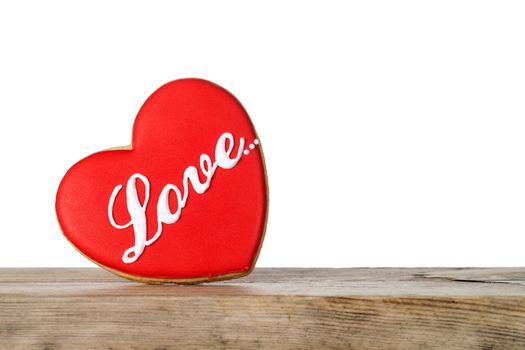 Valentine love cookie in shape of heart on wooden table isolated on white background, Valentine's Day. Front view