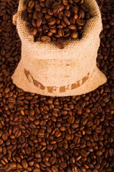 Burlap sack of coffee beans on the coffee beans background