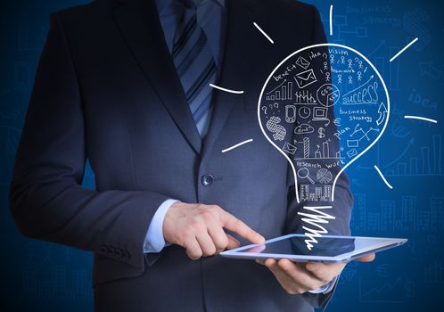 Man in suit holding tablet pc. Above the screen of the tablet are business sketches