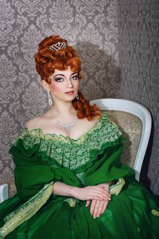 Attractive young girl in green gown and red wig