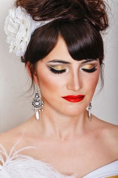 Attractive young woman with high hair and great makeup shot closeup