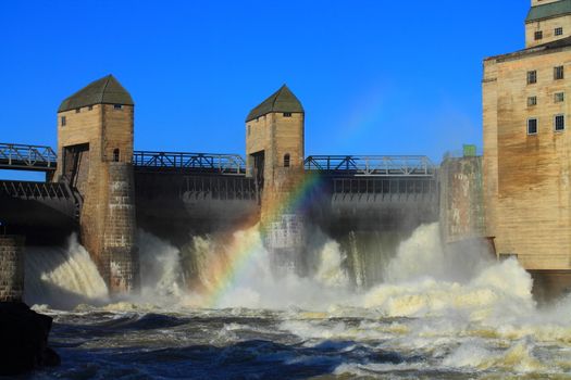 a hydro power plant and rainbow in norway