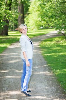 Blond walking away looking at camera