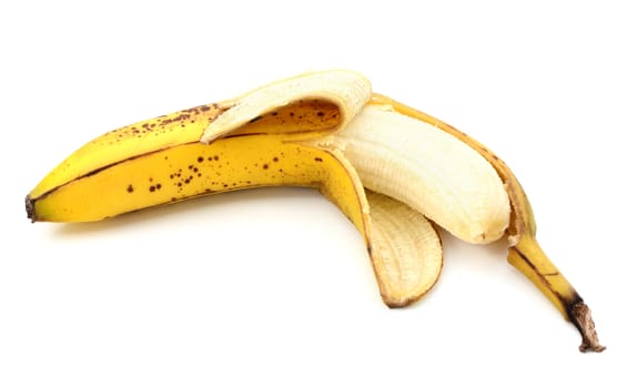 Half-peeled overripe, spotty banana, isolated on a white background
