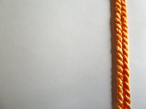 Two bright stripes of golden rope on a white background