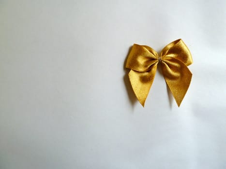 Bright gold ribbon on a plain white background