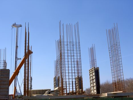 Start of concrete monolithic frame of new building on the background blue cloudless sky