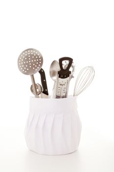 kitchen cooking equipment, chefs hat with utensils.