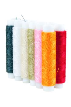 Colored spools of threads isolated on white background