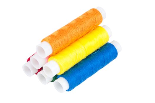 Colored spools of threads isolated on white background