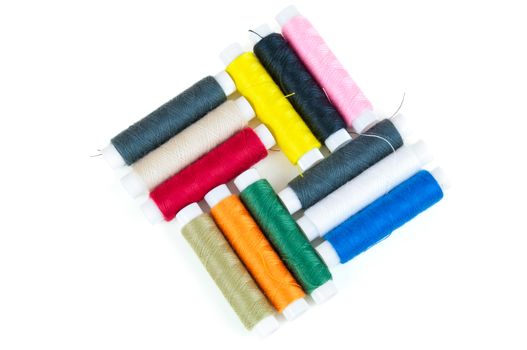 Colored spools of threads isolated on white background