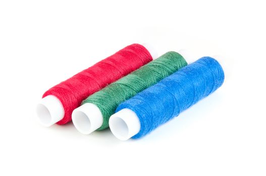 Spools of threads in RGB colors isolated on white background