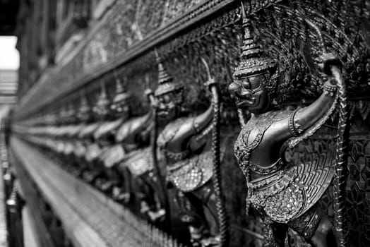 The Grand Palace. Temple of the Emerald Buddha. Gold ornamental patter statuettes.