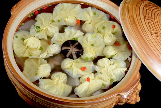 Chinese Food:  Boiled dumplings in a clay pot