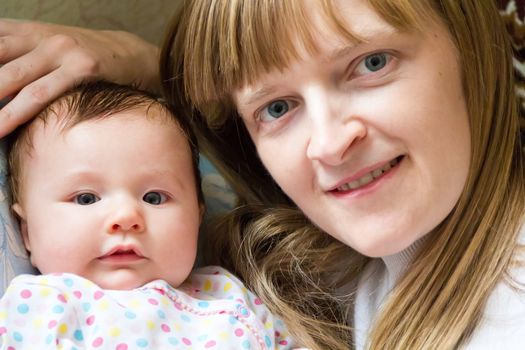 Photo of cute newborn infant girl and mother