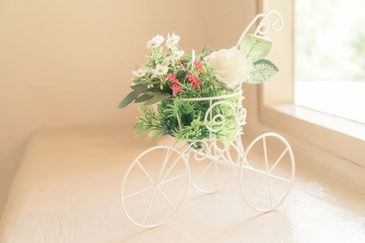 Vintage tone bicycle with artificial flower -  home interior