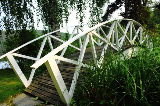 a white bridge over a river