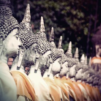 Row of Buddha statue in vintage style