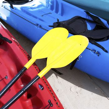 Yellow kayak oar on the red kayak 