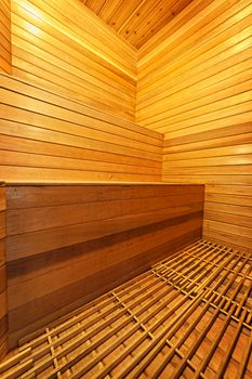 Finnish home sauna interior with wooden bench walls and floor