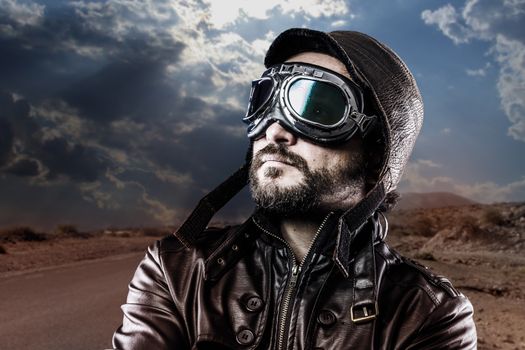 biker with black leather jacket and old glasses
