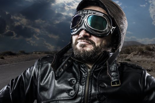 biker with black leather jacket and old glasses