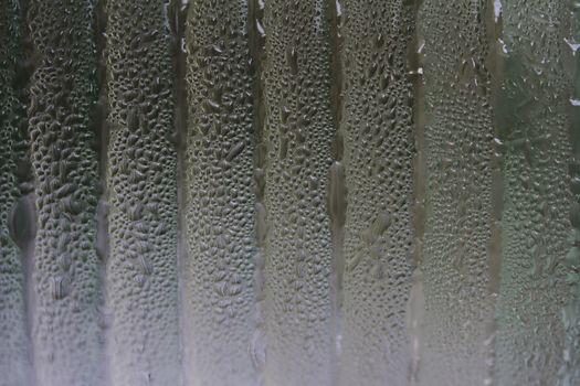 a jar covered with water condensation droplets lined up 
