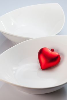 Two white bowls and red heart