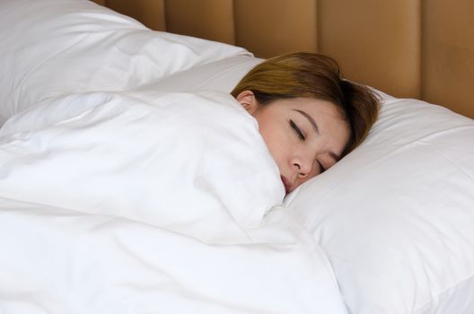 Of Asia woman sleeping on white bed.