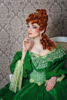 Attractive young girl in green gown and red wig