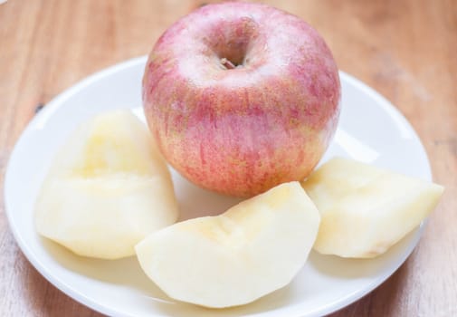 Red apple peeled on the dish, stock photo