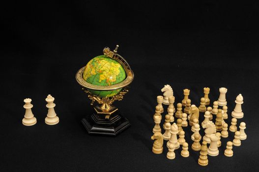 Globe And White Chess on a Black Background