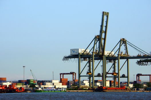 HO CHI MINH CITY, VIET NAM- MARCH 14: Shipping system at Cat Lai port, elevator loading container of freight to vessel, service for import, export good in maritime transport, Vietnam, March 14, 2014