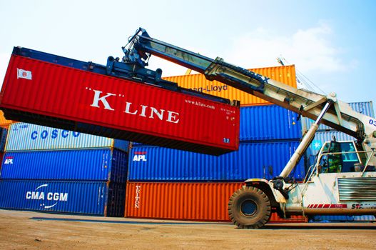 HO CHI MINH CITY, VIET NAM- MAR 19 :  Forklift truck crane container at  freight depot, cargo box in stack, this industrial port is logistic service of import, export  goods ,Vietnam, Mar 19, 2014