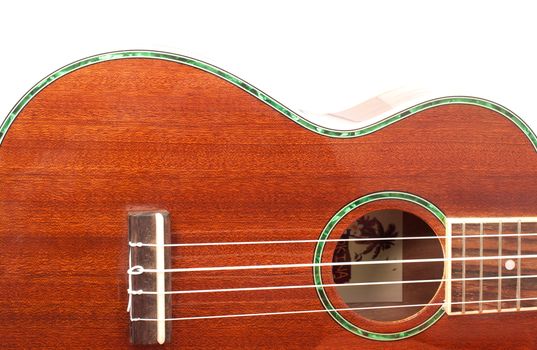 Ukulele guitar brown color and a white background